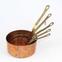 A set of six graduated copper saucepans with riveted brass handles, largest 16cm dia.