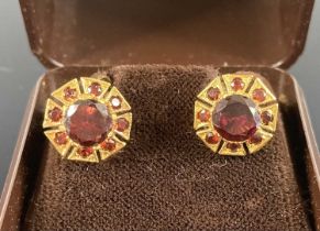 A pair of 9ct gold garnet set ear clips with screw backs, setting dia., 11mm, gross weight 3.2g