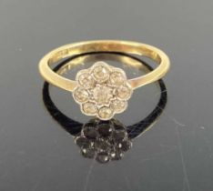 An Art Deco period 18ct gold diamond set flower head cluster ring, setting dia. 8.5mm, 1.9g, size