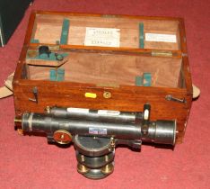 An early 20th century patinated brass theodolite having a bubble level tube with rack and pinion