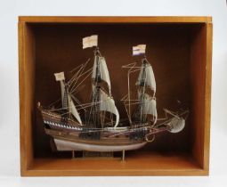 A painted plastic kit of The Golden Hind mounted in glazed display case 33x40cm