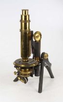 A 19th century lacquered brass monocular microscope having a rack and pinion action on a cast iron