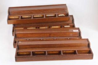 A set of four oak scientific drawers, each having five apertures to house microscope slides, width