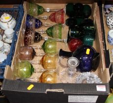 A collection of glass ware to include a set of five coloured glass goblets, wine hocks, and table