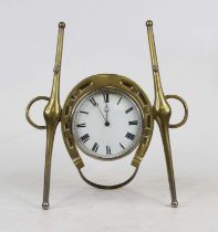 An early 20th century brass cased strut clock in the form of a horseshoe and yokes, having an