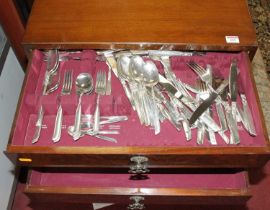 A walnut table canteen of community plate cutlery