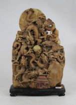 A Chinese hardstone double sided carving in the form of six dragons chasing a pearl mounted to an