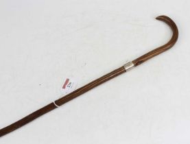 A late 19th/early 20th century hawthorn walking cane having a white metal collar, 87cm long