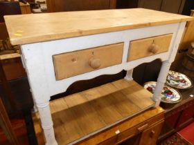 A rustic pine and part painted two drawer dresser base, having a pot board undertier, width 105cm