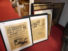 A selection of framed newspaper front pages and cuttings, primarily of World war Two interest