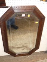 A 1920s oak octagonal bevelled wall mirror, 82 x 54cm