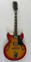 A 1960's Shaftesbury model 3264 hollow body electric guitar, the laminated maple body in cherry