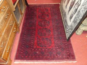 A Persian woollen red ground bokara rug, having multiple trailing tramline borders, 195 x 112cm