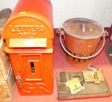 A George V period cast iron and later red painted letterbox, h.52cm, with a spare door and lock; and