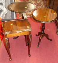 Two contemporary mahogany low pedestal tripod occasional tables, together with a single mahogany