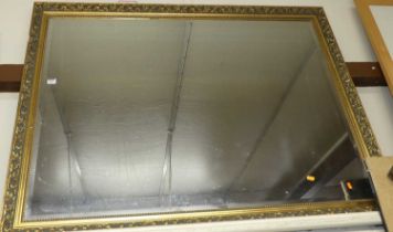 A gilt framed and bevelled rectangular wall mirror, 103 x 134cm