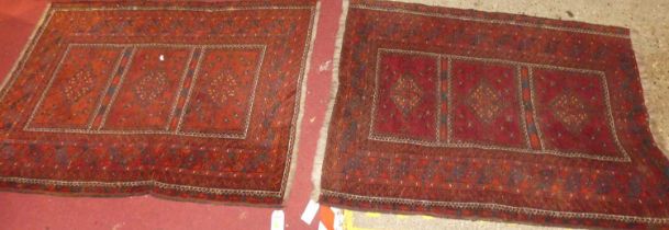 A Persian woollen red ground bokhara rug, 137 x 102cm, together with one other (2)