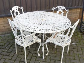 A Victorian style white painted galvanised pierced metal patio suite, comprising; circular table,