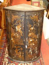 A 19th century black chinoiserie lacquered and further gilt decorated bow front double door