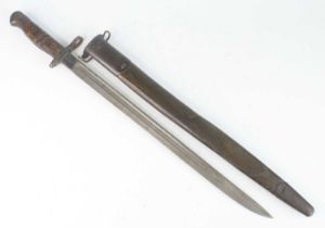 A Remington M1917 bayonet, the 43cm single edged fullered blade marked to the ricasso 1917 Remington