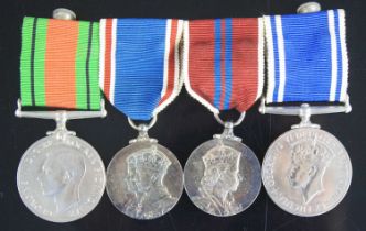 A group of four medals, to include WW II Defence medal, George VI Coronation, Elizabeth II