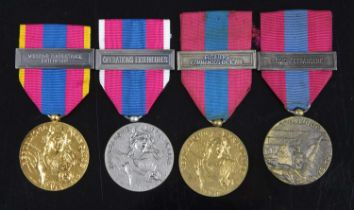 A collection of four Republique of Francais Defence medals (Medaille de la French Nationale) in gold
