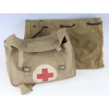 A British Army 1937 webbing pattern First Aid kit bag dated 1955 containing various field