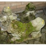 A pair of reconstituted stone garden gate post finials, together with a garden concrete recumbent