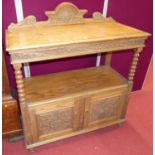 An early 20th century floral relief carved oak ledge back two-tier buffet, having bobbin turned