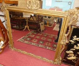 A Victorian floral gilt wood decorated over mantel mirror (losses and damages to frame), 130 x