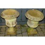 A pair of reconstituted stone pedestal urn garden planters, each dia 43cm