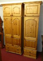 A modern pine double door wardrobe, having twin cupboard door upper section and twin lower