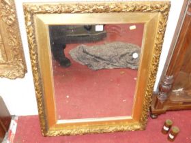 A 19th century floral gilt wood framed rectangular wall mirror, with moulded leaf and berry pattern,