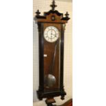 An early Victorian walnut and ebonised Vienna wall clock circa 1840, having a white enamel dial (