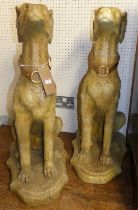 A pair of painted composite seated hunting hounds raised on integral shaped bases, height 80cm
