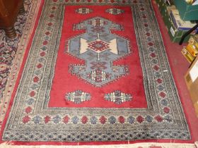 A Persian woollen blue ground Bokhara rug, 185 x 125cm, together with a Persian woollen red ground