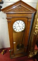 A late 19th century oak cased Vienna wall clock by Lenzkirk, having an unsigned white enamel Roman