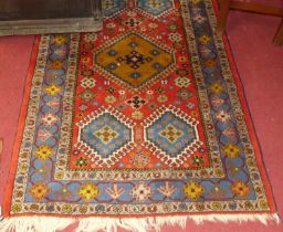 A Turkish woollen red ground Oushak rug, 162 x 102cm
