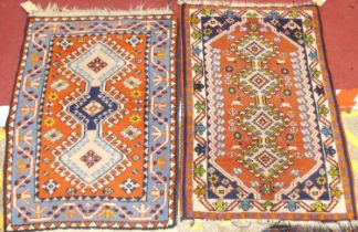 A near pair of Persian red ground woollen Shiraz hall rugs, each 80 x 57cm