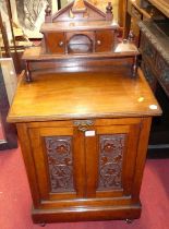 A late Victorian walnut coal purdonium having a raised superstructure, the hinge compartment with