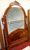 A Victorian mahogany and flame mahogany single bedstead, the imposing high arched headboard with