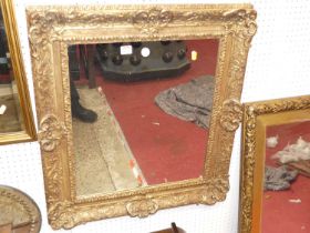 An early 20th century heavily floral gilt wood framed rectangular wall mirror, 73 x 66.5cm