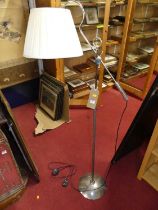 A contemporary nickel plated chrome standard lamp, with swivel and adjustable branch arm action on