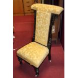 A late Victorian ebonised and mustard floral fabric upholstered prie-dieu, width 51cm