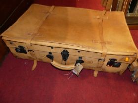 A stitched hide suitcase with metal fittings