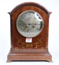 An Edwardian mahogany and brass inlaid dome top mantel clock having an unsigned silvered Roman