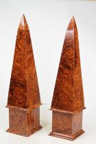 A pair of 20th century amboyna table obelisks, each height 46cm