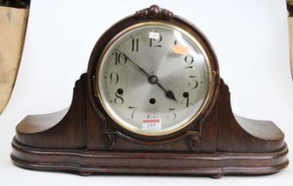 A circa 1920 German "Napoleons hat", oak cased mantel clock, having a silvered Arabic dial with
