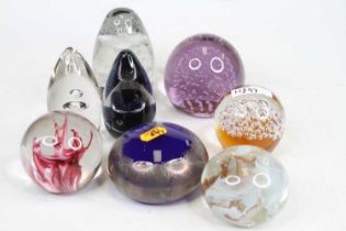 A collection of coloured glass paperweights