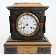 A late Victorian walnut and ebonised mantel clock, having a white enamel Roman dial (hairline) and